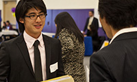 A student talking to employers at the career fair