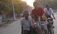 A study abroad student riding a bike in Myanmar